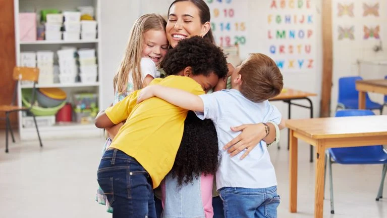 Children showing care and compassion with their teacher