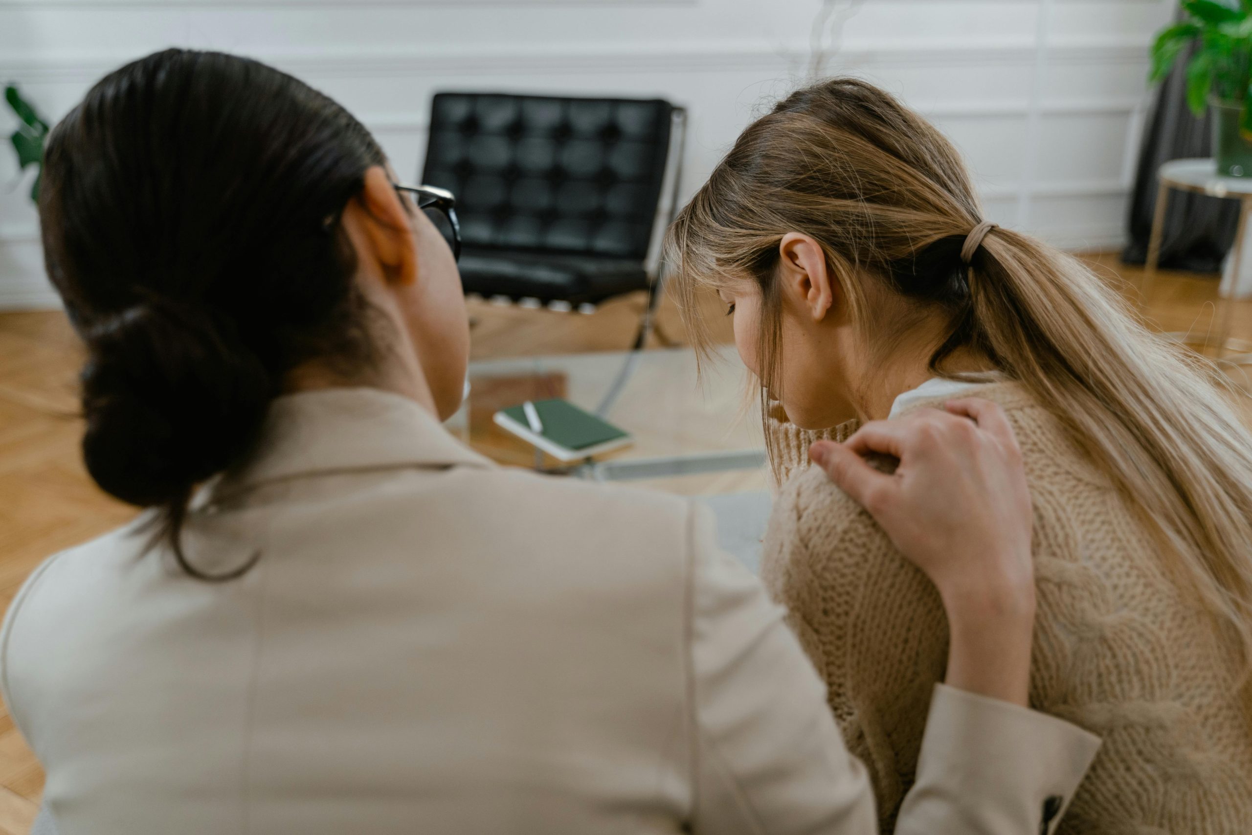 person comforting the sad woman